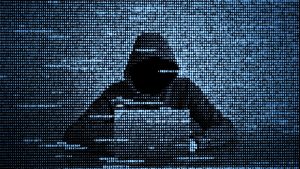 Hacker in data security concept. Hacker using laptop. Hacking the Internet. Cyber attack.